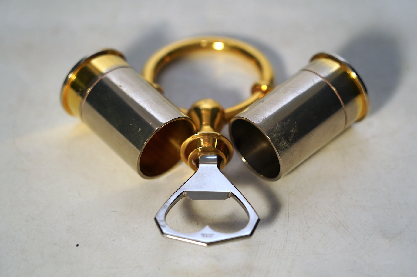 A pair of Hermes 'shotgun cartridge' handles and bottle opener